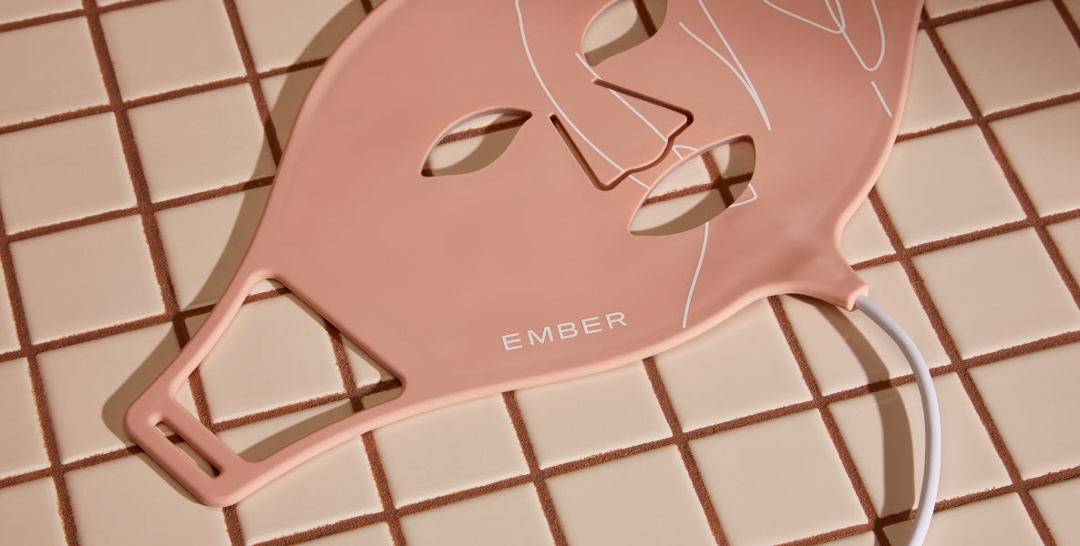 The Ember LED Light Therapy Mask rests on a tiled surface. Complete with three modes, the Ember Wellness LED Light Therapy Mask offers professional light therapy with proven results in the comfort of your home.