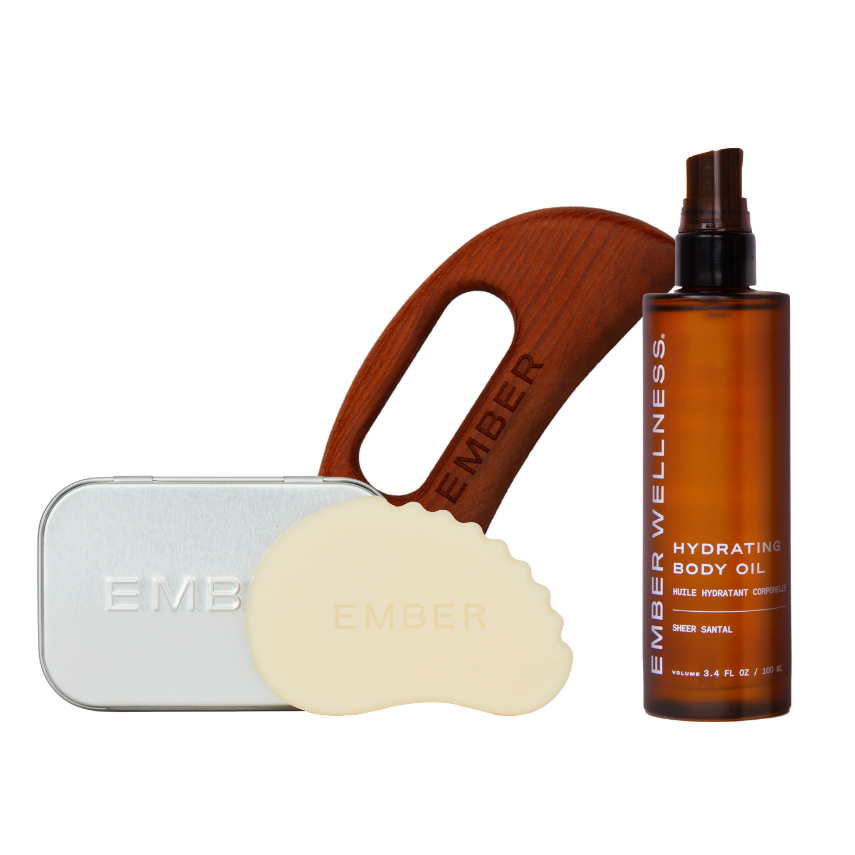 Body care products including a wooden-handled tool, a metal container, and a brown bottle on a white background.