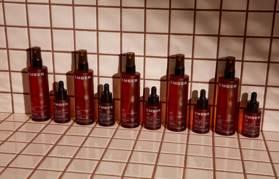 Ember's oil and water duos combine to deliver the maximum amount of nutrients to the skin leaving your skin perfectly balanced, beautiful, and supported. Pictured here, Ember oils and hydrosols rest on a tiled surface.