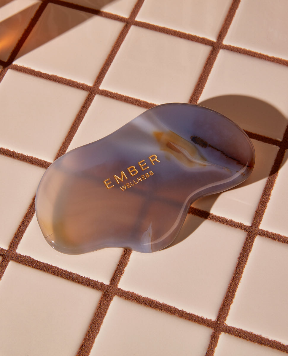 Our patented Cloud Gua Sha tool designed to hug every curve on the body, seen here in amethyst.