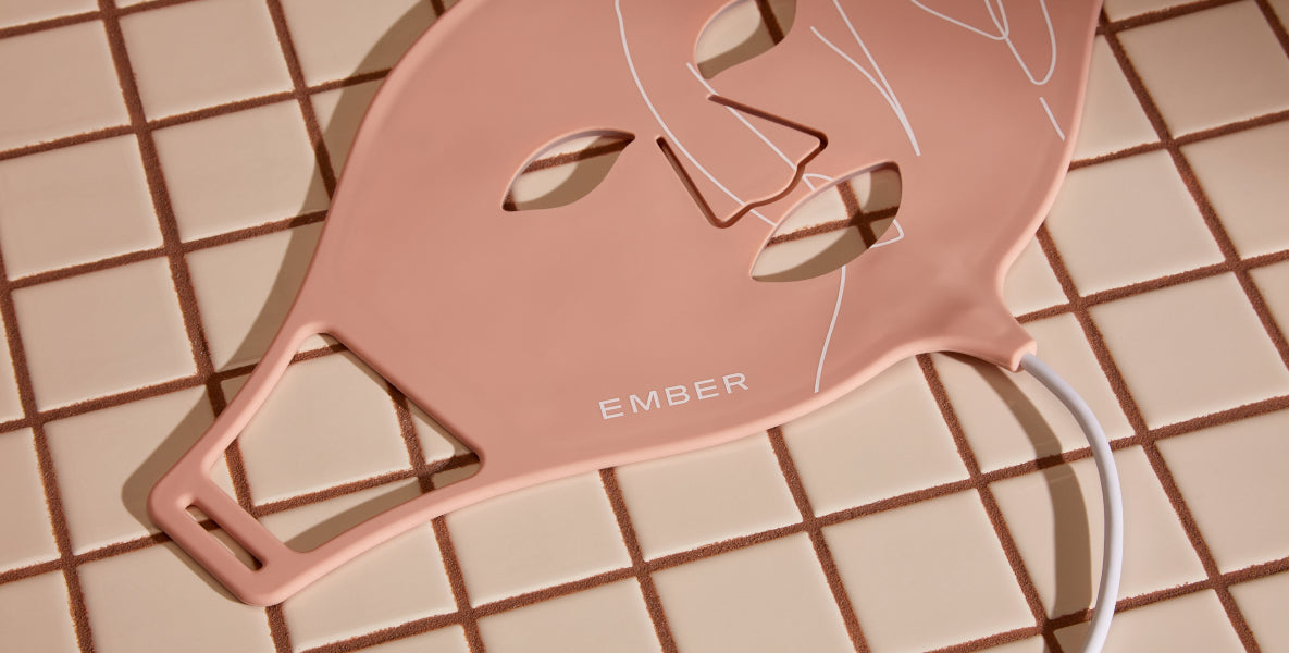 The Ember LED Light Therapy Mask rests on a tiled surface. Complete with three modes, the Ember Wellness LED Light Therapy Mask offers professional light therapy with proven results in the comfort of your home. 