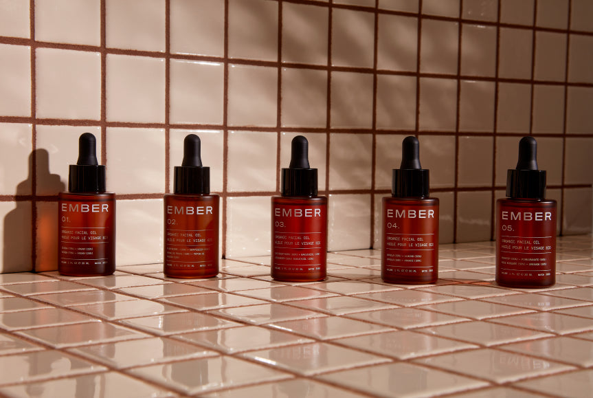 All five Ember Wellness oils (1oz) rest on a tiled surface.