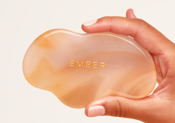 Our patented Cloud Gua Sha tool designed to hug every curve on the body, seen here in agate.