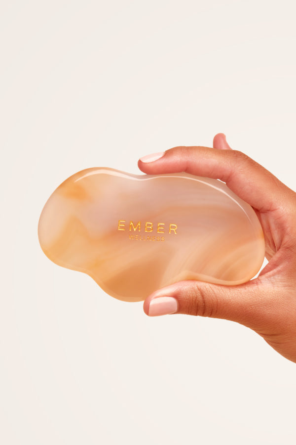 Our patented Cloud Gua Sha tool designed to hug every curve on the body, seen here in agate.