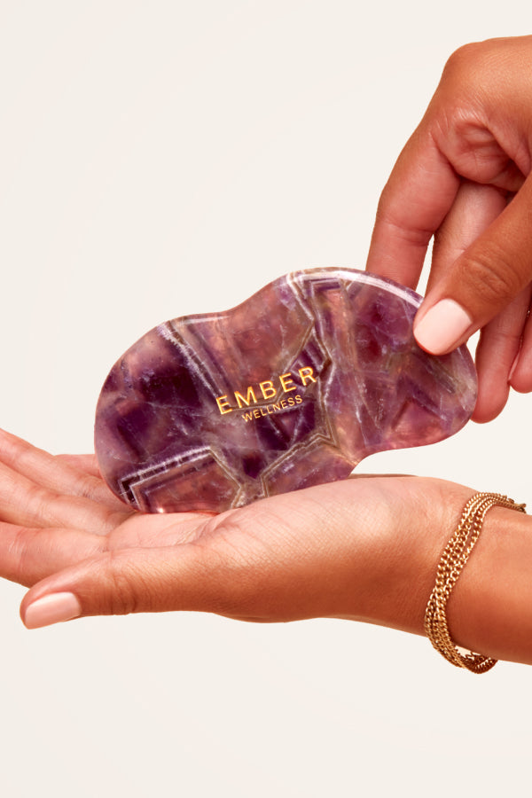 Our patented Cloud Gua Sha tool designed to hug every curve on the body, seen here in amethyst.