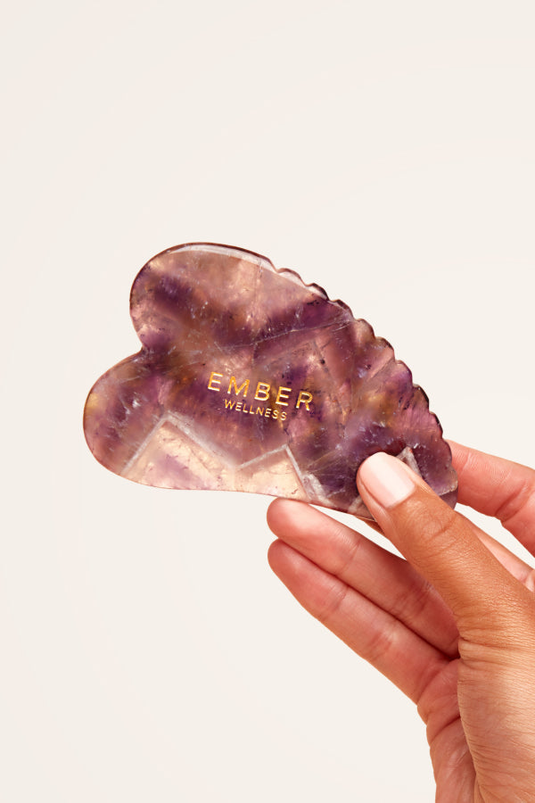Our patented Heart Gua Sha tool designed for optimal facial support, seen here in amethyst.